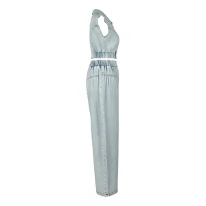 Side view of light wash sleeveless denim crop top and high waist wide leg pants set
