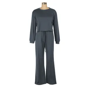 Detail view of a dark grey long-sleeve crop top and wide-leg drawstring pants tracksuit set