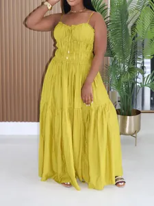 Full-length mustard yellow bohemian tiered maxi dress with spaghetti straps and smocked bodice