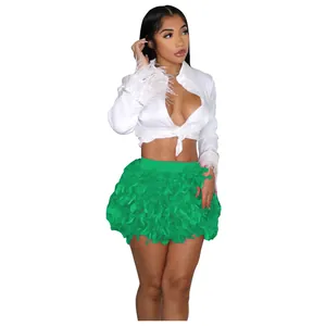 Fashionable white tie-up crop shirt paired with a vibrant green turkey feather mini skirt