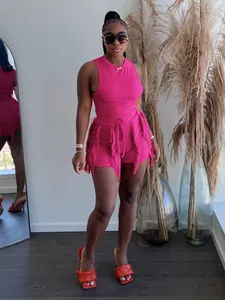 Detail view of hot pink fringe two-piece set including a ribbed tank top and shorts.