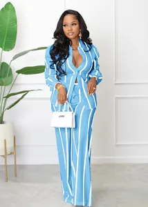 Full-body shot of a professional woman wearing a blue and white striped shirt and pants set