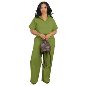 Stylish olive green two-piece linen-look set with short sleeve shirt and wide-leg pants.