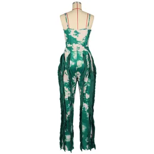 Rear view of green tie-dye jumpsuit with long fringe trim on legs