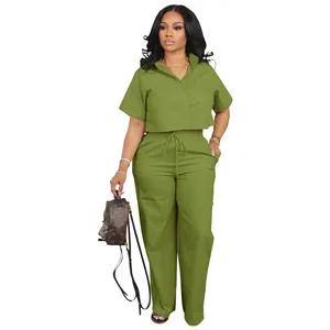 Full body view of a women's casual green linen two-piece shirt and long pants set