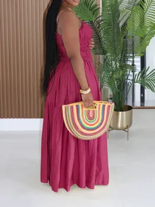 Detailed side view of a magenta sleeveless bohemian tiered maxi dress for summer.