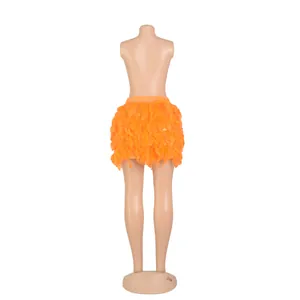Detailed back view of a vibrant orange turkey feather mini skirt on a mannequin display