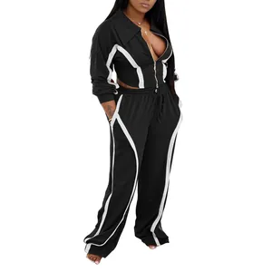 Two-piece black and white tracksuit set with zip jacket and wide-leg joggers for women