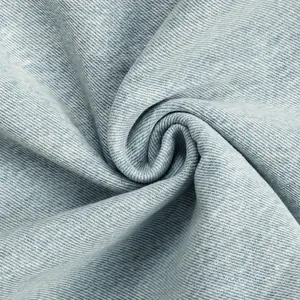 Macro close-up view of light blue denim fabric texture with distinct twill weave pattern detail