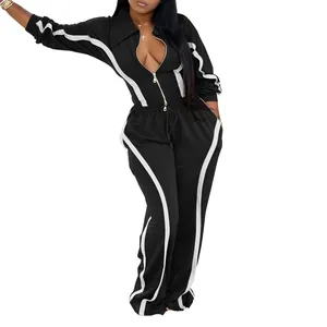 Detail of women's two-piece black tracksuit with white stripe accents for winter.