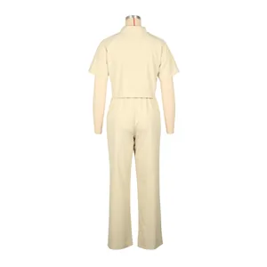 Back view of a cream two-piece casual set featuring a short-sleeved shirt and long trousers