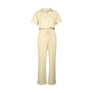Close-up detail of a beige two-piece linen blend lounge set with crop shirt and pants.
