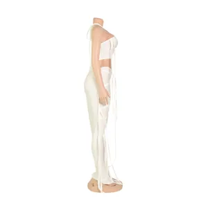 Profilo laterale di un sexy set due pezzi bianco con crop top e pantaloni a strisce su manichino
