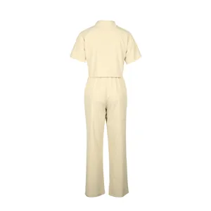 Back view of a casual beige linen-blend two-piece short-sleeve shirt and pants set.