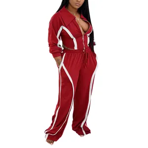 Full-length detail shot showing the fit and contrast stripe design of the red sports suit