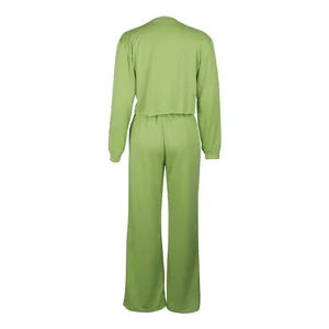 Detailed back view of a light green two-piece tracksuit set with crop top and wide pants.