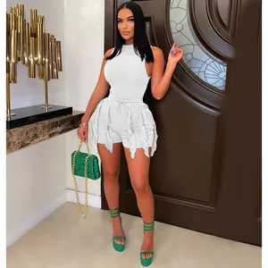 Close-up of white two-piece fringe set featuring sleeveless top and tassel shorts