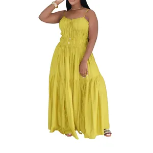 Detailed shot of a yellow bohemian tiered maxi dress featuring adjustable camisole straps