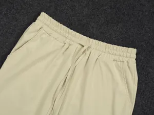 Close-up detail of high elastic waistband with drawstring on beige linen leisure pants