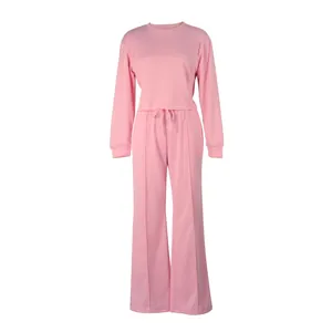 Full view of pink two-piece tracksuit featuring long-sleeve sweatshirt and wide-leg pants