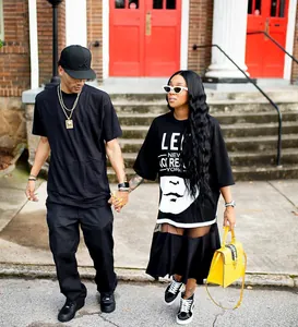 Modern plus size black T-shirt dress featuring a mesh splice and bold artistic graphic print