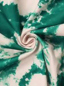 Close-up of green and white tie-dye fabric texture showing detailed print pattern