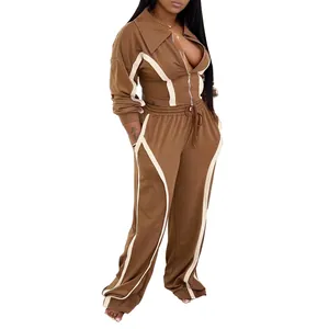 Stylish women's brown two-piece tracksuit with contrast paneling and zip jacket.