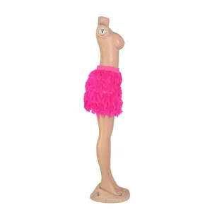Side view detail of a vibrant pink turkey feather mini skirt on a mannequin for party wear