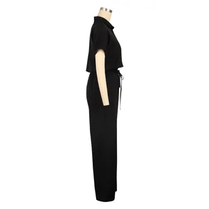 Detailed side view of minimalist women's black linen short sleeve shirt and trousers set