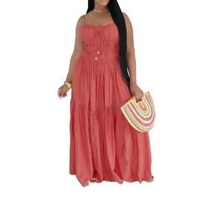 Detail view of terracotta tiered maxi dress with ruched bodice and drawstring accents.
