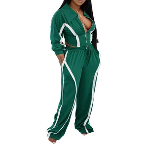 View of the green athletic tracksuit showing white curved stripe details on the full set