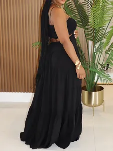 Side view of a black bohemian tiered maxi dress with strappy sleeveless design.