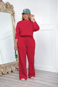 Stylish women's two-piece red lounge set featuring a cropped sweatshirt and wide-leg joggers.