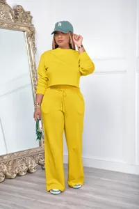 Two-piece yellow tracksuit set featuring long sleeve sweatshirt and matching wide-leg pants