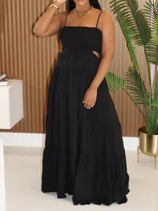 Detail view of black bohemian tiered maxi dress with side cut-outs and spaghetti straps.