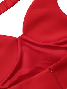 Close-up detail of red party dress featuring a smooth fabric texture and invisible zipper