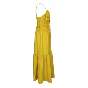 Side view of a yellow bohemian tiered maxi dress featuring ruched bodice details