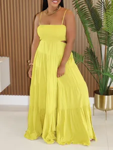 Bohemian tiered yellow spaghetti strap maxi dress with cutout waist detail