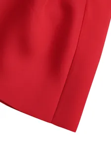 Detailed close-up showing the high-quality red fabric texture and neat hemline of the dress