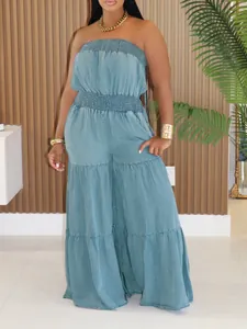 Detailed shot of a stylish blue strapless tiered smocked denim jumpsuit on a model