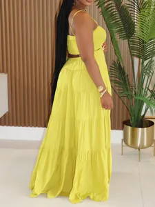 Detail view of a vibrant yellow Bohemian tiered maxi dress with smocked bodice.