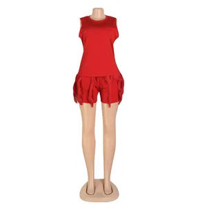 Detail shot of vibrant red two-piece set featuring sleeveless tank top and fringe shorts