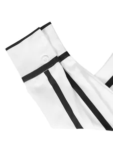 Detailed close-up of a white shirt sleeve cuff featuring black stripe accents and a button