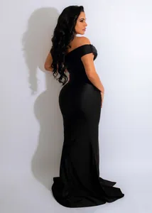 Back view of a sleek off-the-shoulder black evening gown with mermaid silhouette