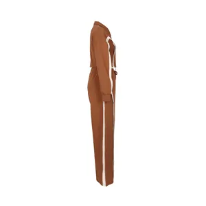 Side view detail of brown cotton 2-piece women's tracksuit featuring white side stripes