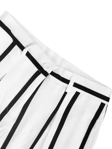 Close-up detail of white and black striped trousers with button and belt loops