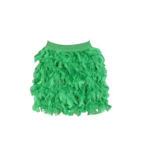 Close-up of vibrant green turkey feather mini skirt featuring dense textured plumage.