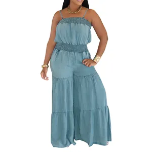 Full view of light blue tiered denim jumpsuit with smocked waist and wide legs