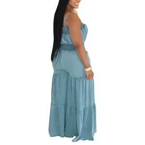 Side view of light blue denim jumpsuit featuring smocked waist and tiered wide legs