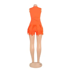 Rear view of vibrant orange two-piece set with fringe shorts on a mannequin